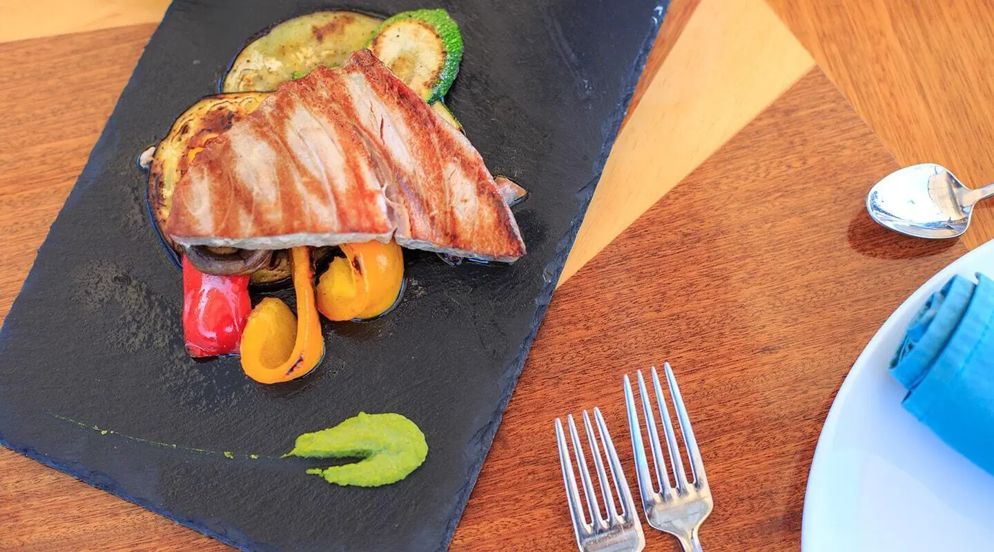 Carpe Diem 7 yacht menu plate with grilled fish, vegetables and lemon