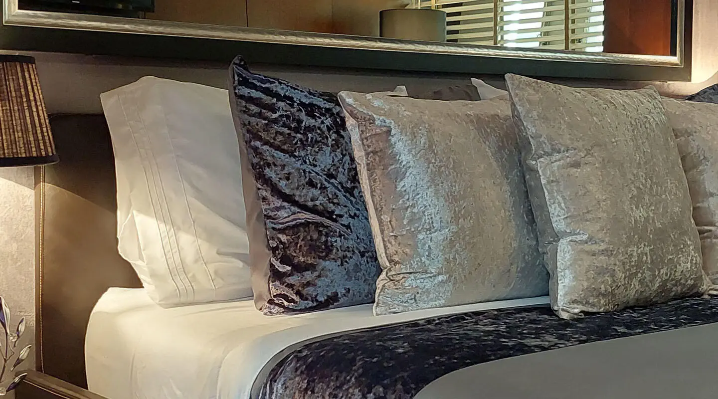 Miraval yacht master cabin with bed and decorative pillows