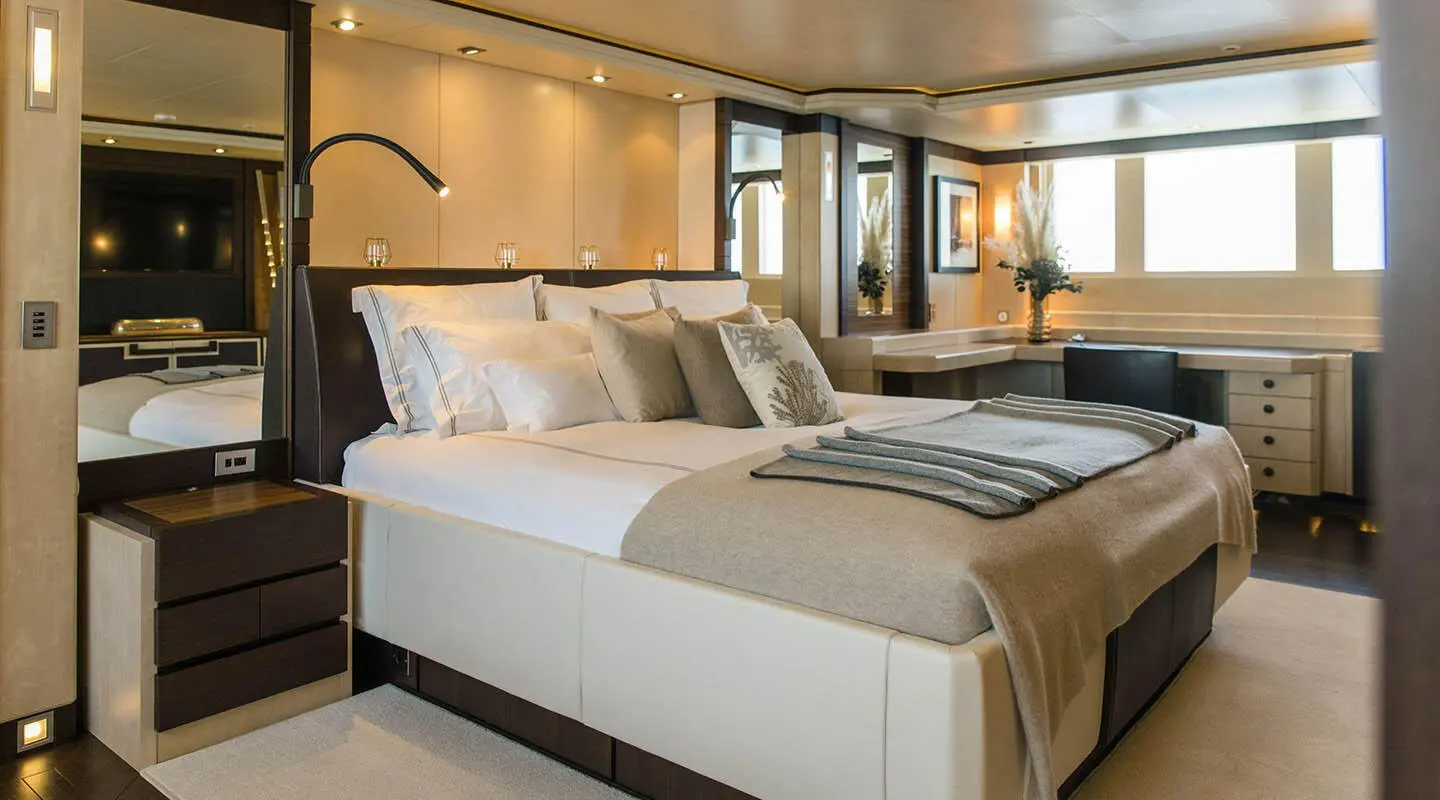 Master bedroom interior of Alalya motor yacht with plush bed and decor