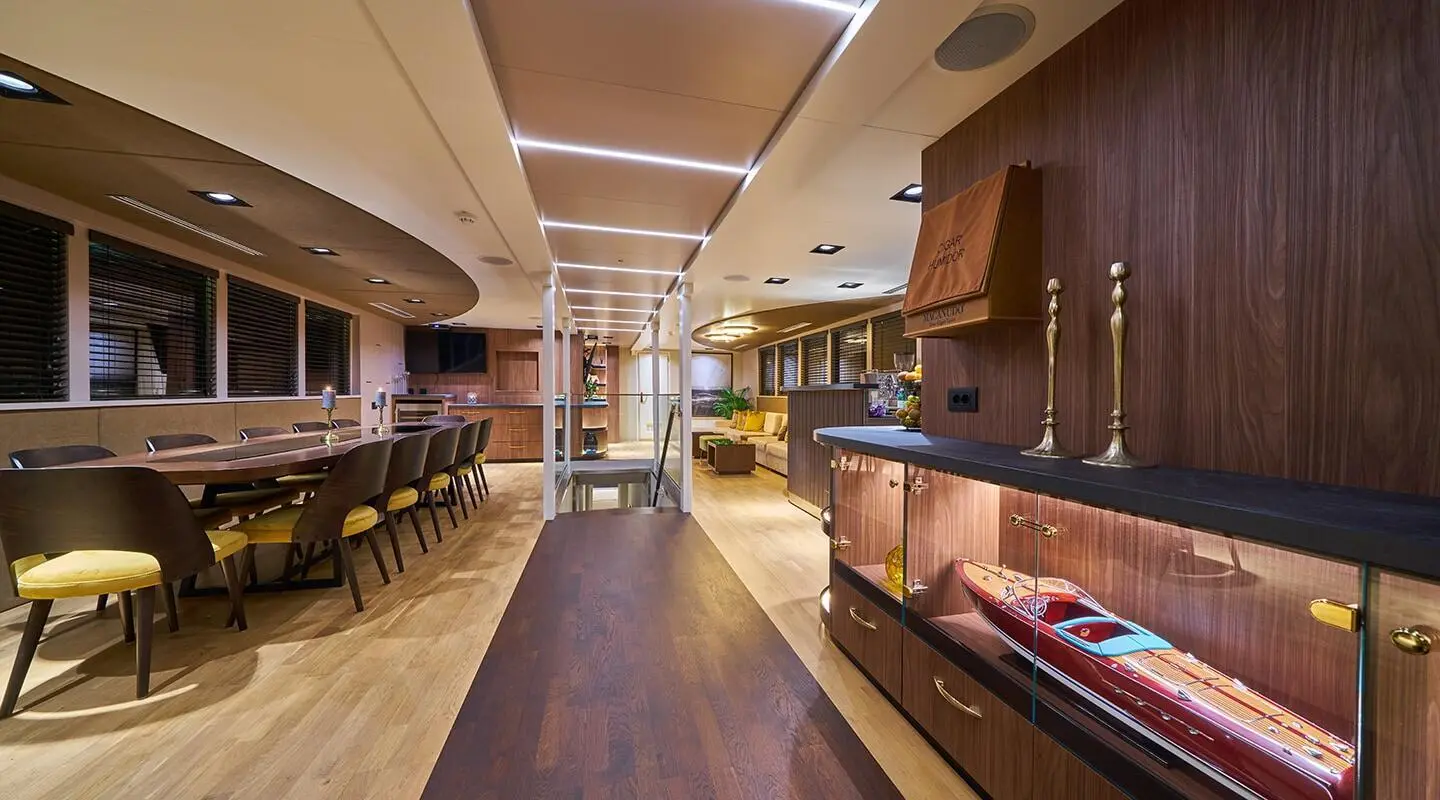 Yacht interior on Rara Avis with polished wood floor and seating area