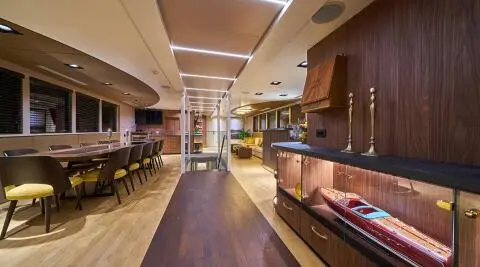 Yacht interior on Rara Avis with polished wood floor and seating area
