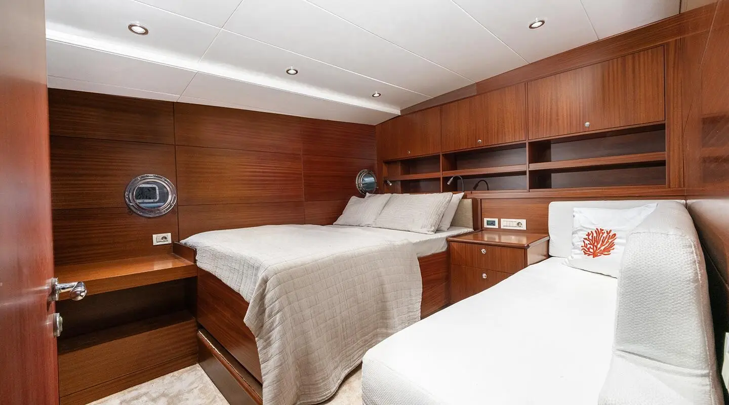Luxurious yacht cabin interior with wooden panels and two beds