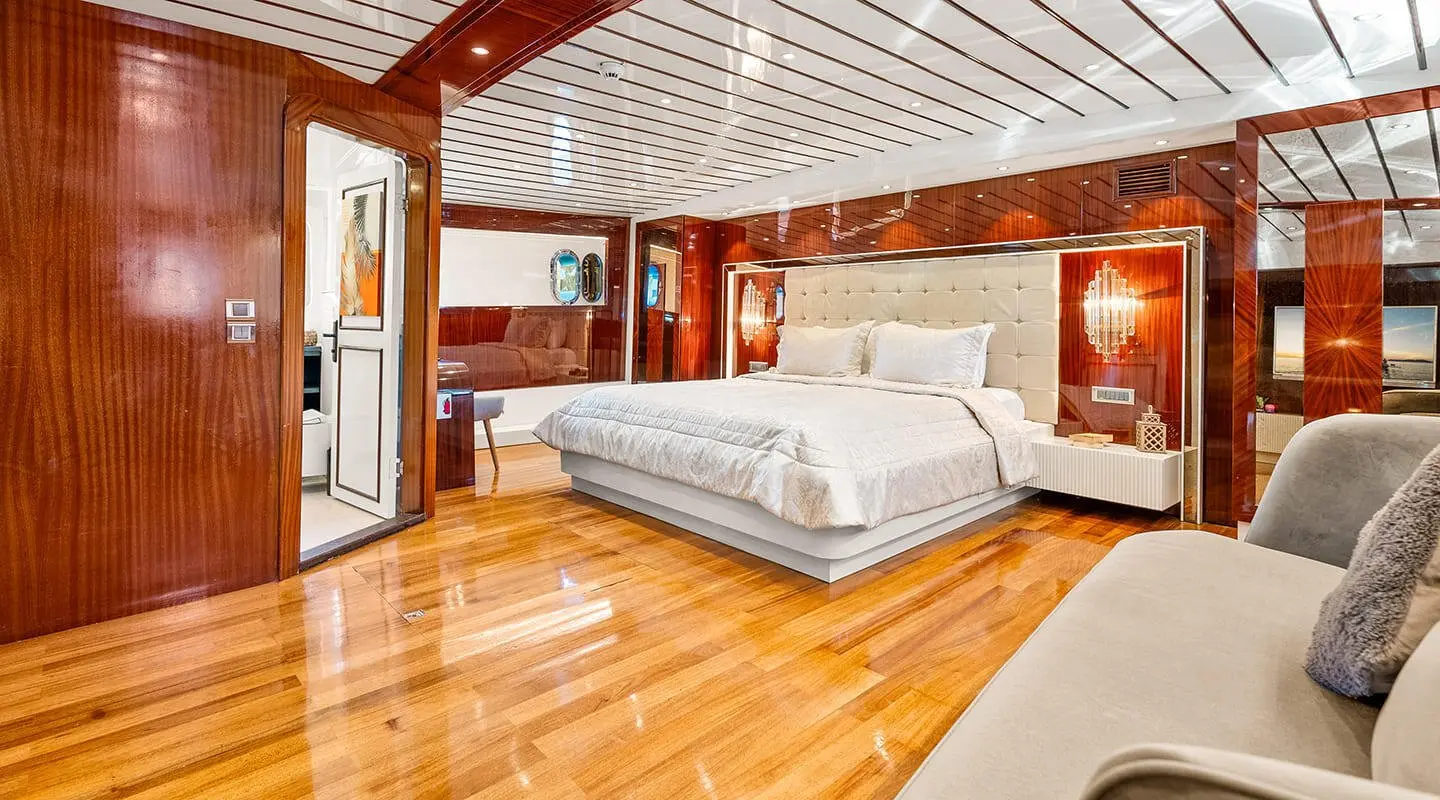 Esma Sultan master cabin on a gulet, wooden deck and white bedding