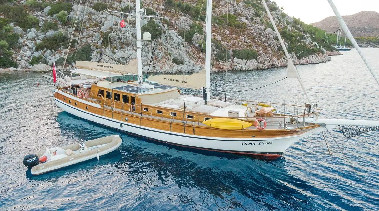 Derin Deniz gulet anchored beside the dock in blue water