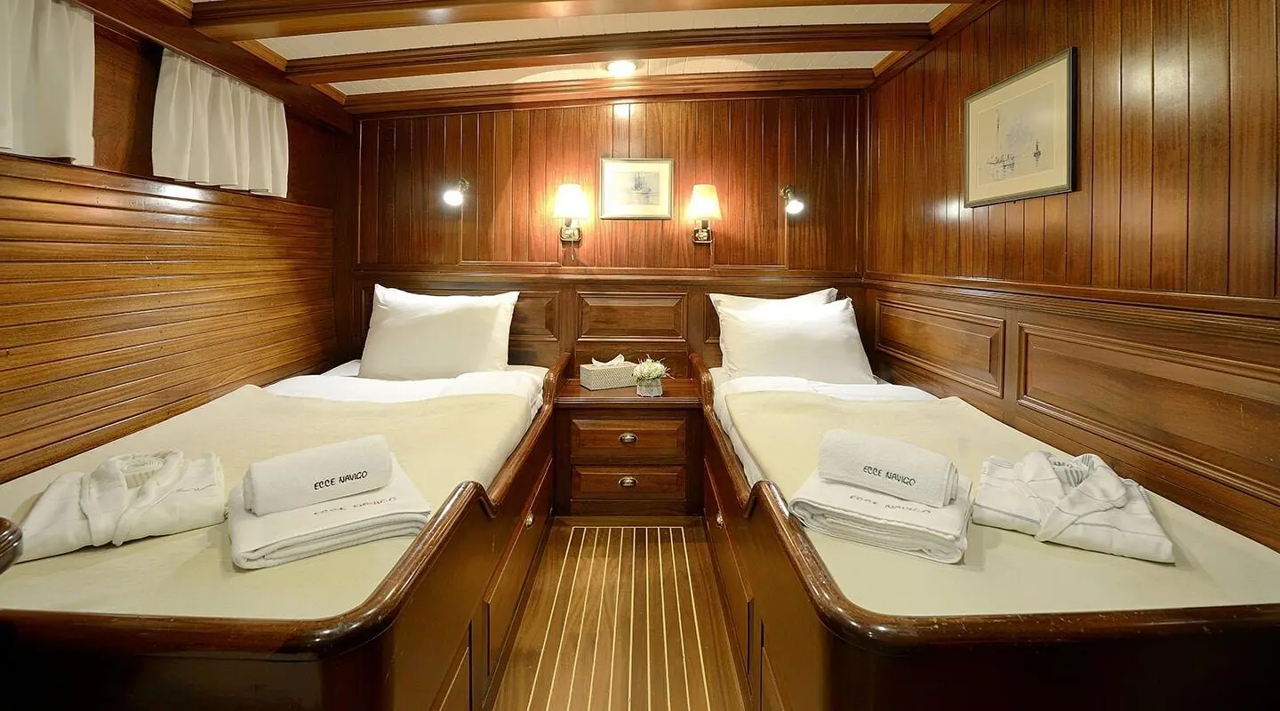 Luxurious yacht Ecce Navigo interior with wooden walls and four beds