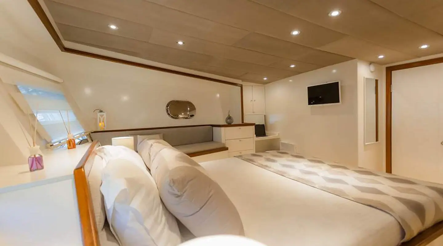 Interior of Grand Sailor luxury gulet with plush cream cushions and wooden deck lighting