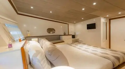 Interior of Grand Sailor luxury gulet with plush cream cushions and wooden deck lighting