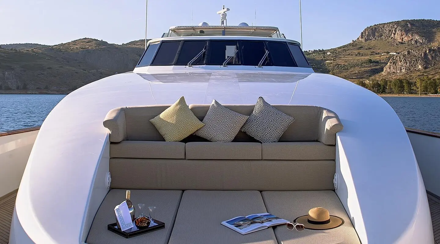 Aquila luxury motor yacht deck with beige seating, cushions, and neat front view