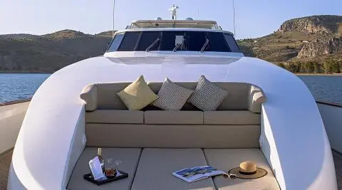Aquila luxury motor yacht deck with beige seating, cushions, and neat front view