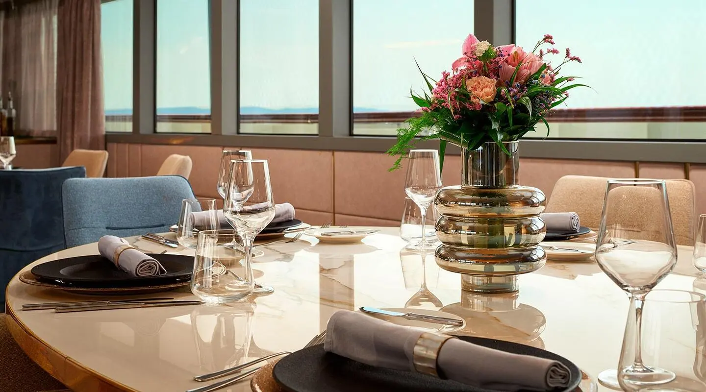 Dining table aboard Ohana yacht with flowers and place settings