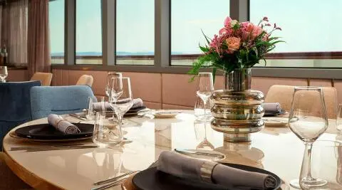 Dining table aboard Ohana yacht with flowers and place settings