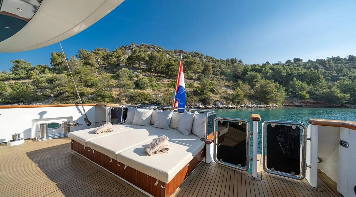 Navilux yacht deck with seating, sun loungers, and railing against blue sea
