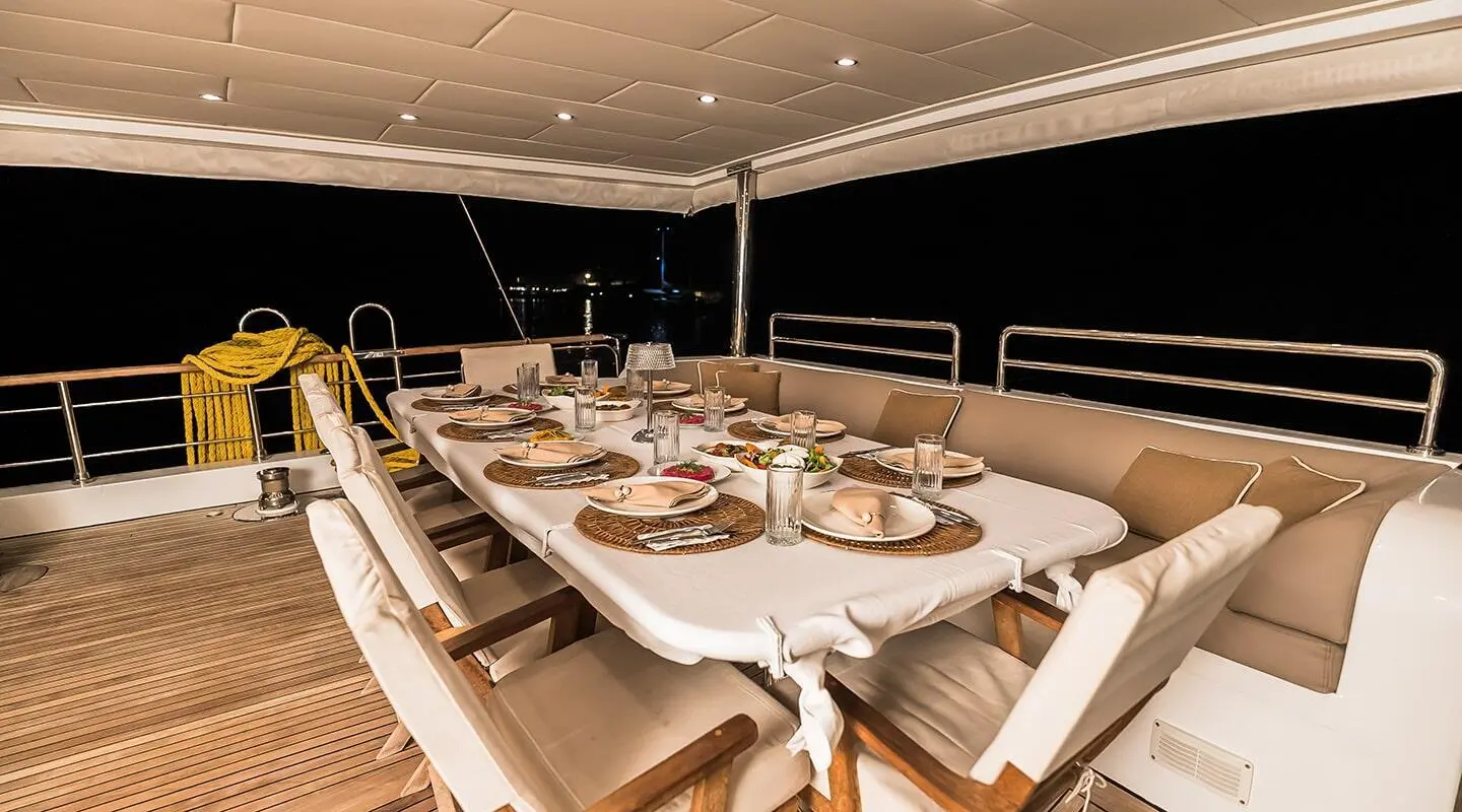 Belgin Sultan luxury gulet at dusk with deck dining setup and ropes