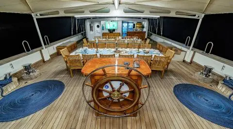 Yacht Tersane 8 helm and teak deck with steering wheel and seating at sunset