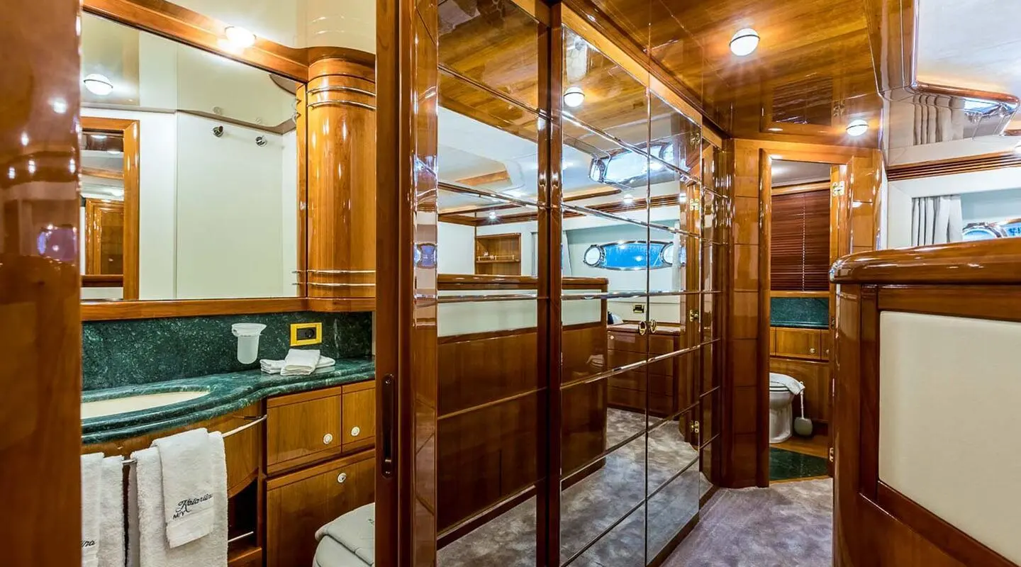 Miss Katariina yacht interior at sunset, glossy wood bar and seating