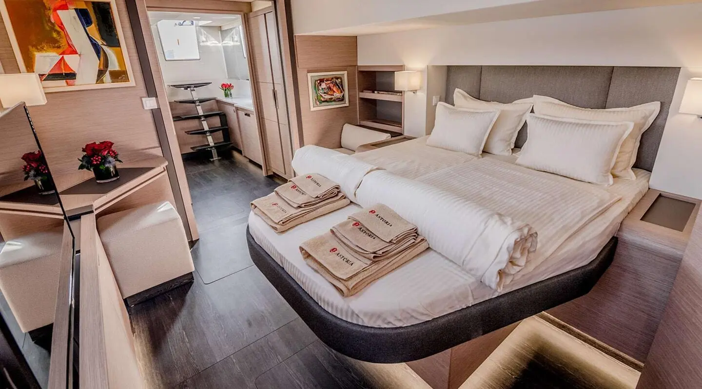Astoria motor yacht interior showing double cabin with bed and towels