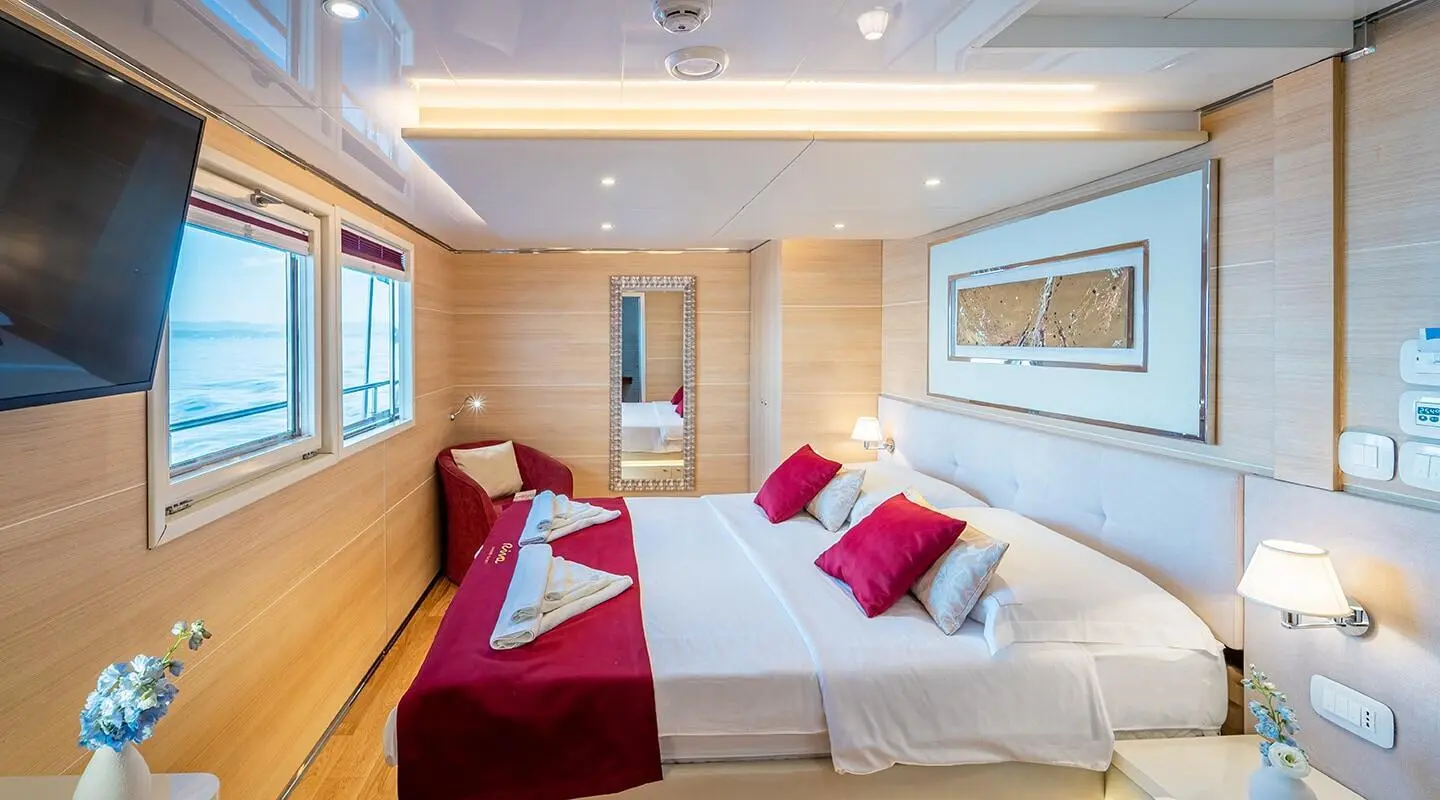 Riva motor yacht with a double cabin, two beds and red pillows visible