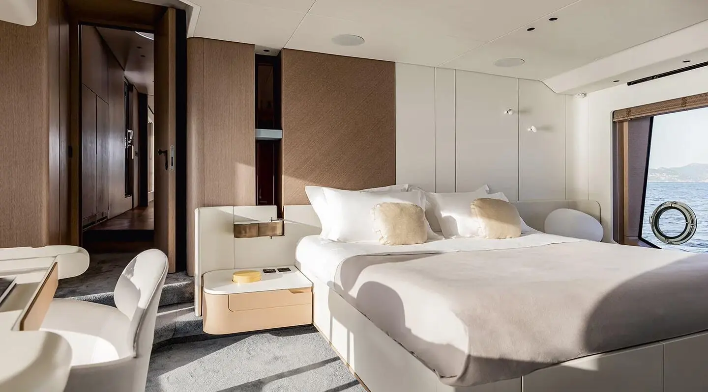 Viva II master suite aboard luxury yacht, wide bed, neutral tones, bedside tables