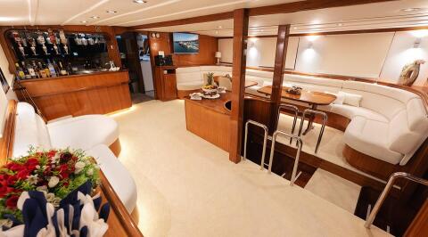 Aurum gulet interior salon with wooden flooring and white seating