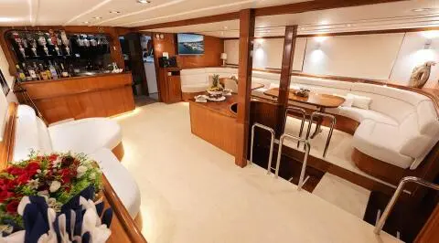 Aurum gulet interior salon with wooden flooring and white seating