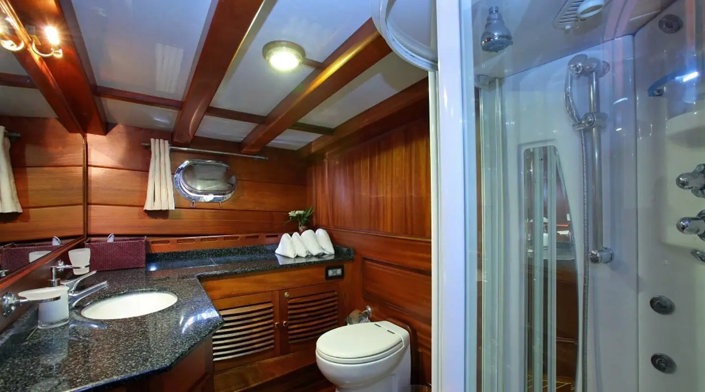 Interior view of Kaya Guneri 4 gulet bathroom with wooden cabinets and toilet