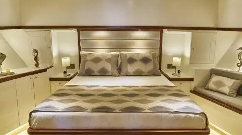 Grand Sailor yacht interior with elegant bed, cushions, and soft lighting