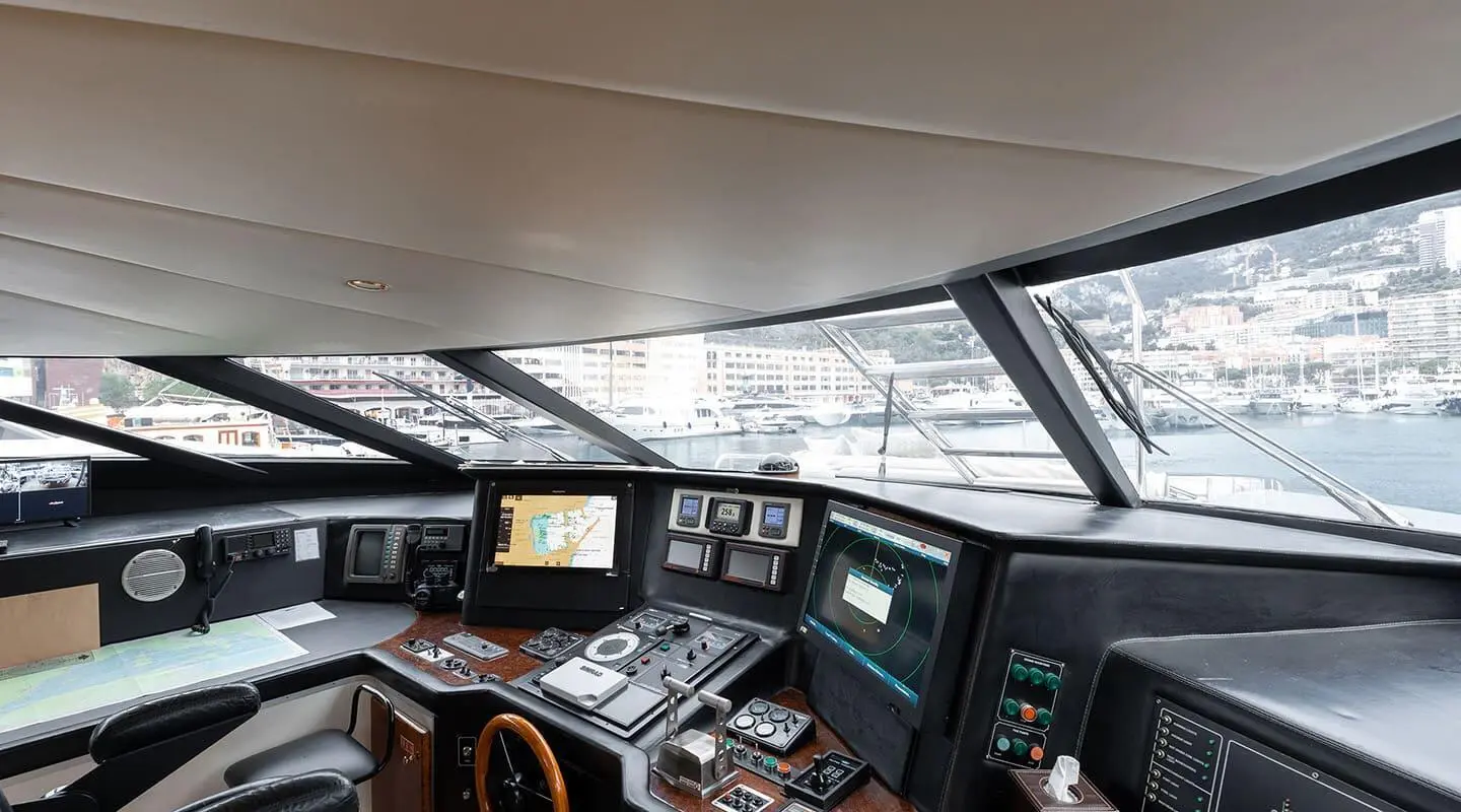 Bridge helm of Brooklyn yacht at sunset, navigation panels and wheel visible