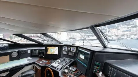 Bridge helm of Brooklyn yacht at sunset, navigation panels and wheel visible