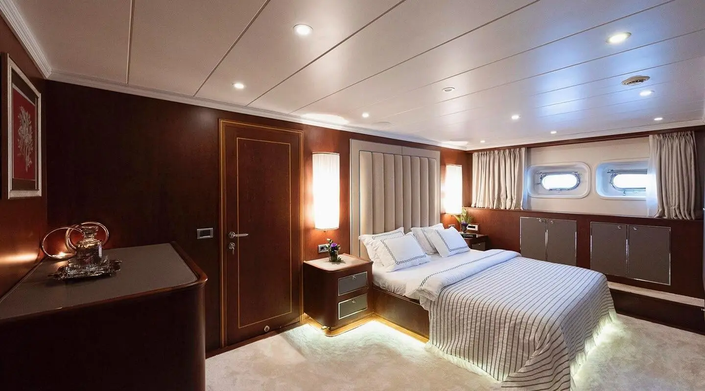 Ocean Breeze motor yacht interior with two beds and wood-paneled cabin