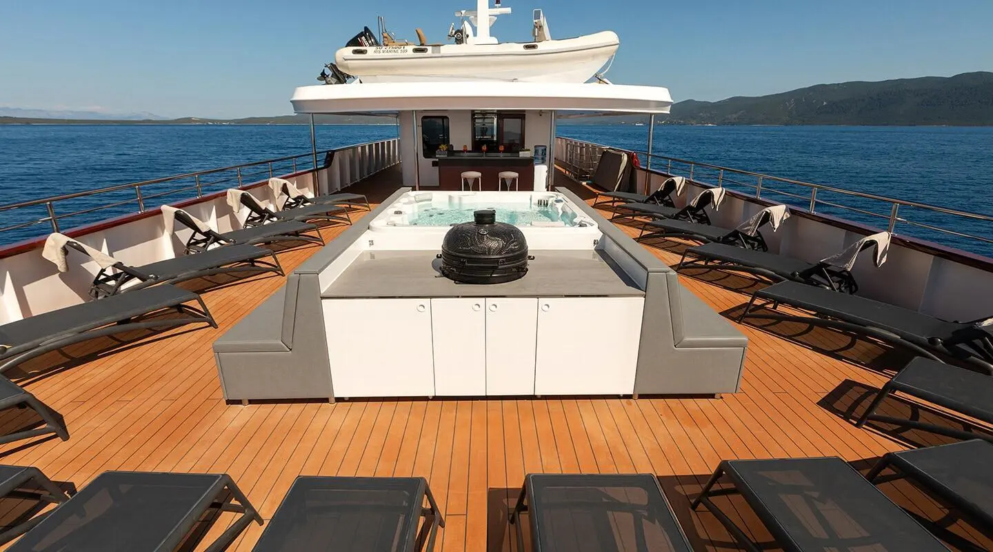 Yolo yacht sun deck with lounge chairs and open deck area