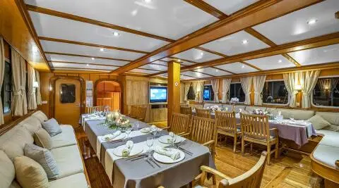 Gulet Tersane 8 saloon interior with wooden furniture and dining tables