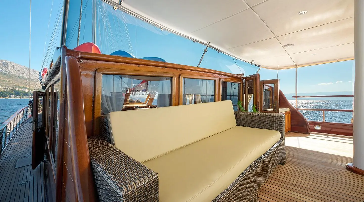 Linda yacht deck seating area under shaded canvas with tan cushions