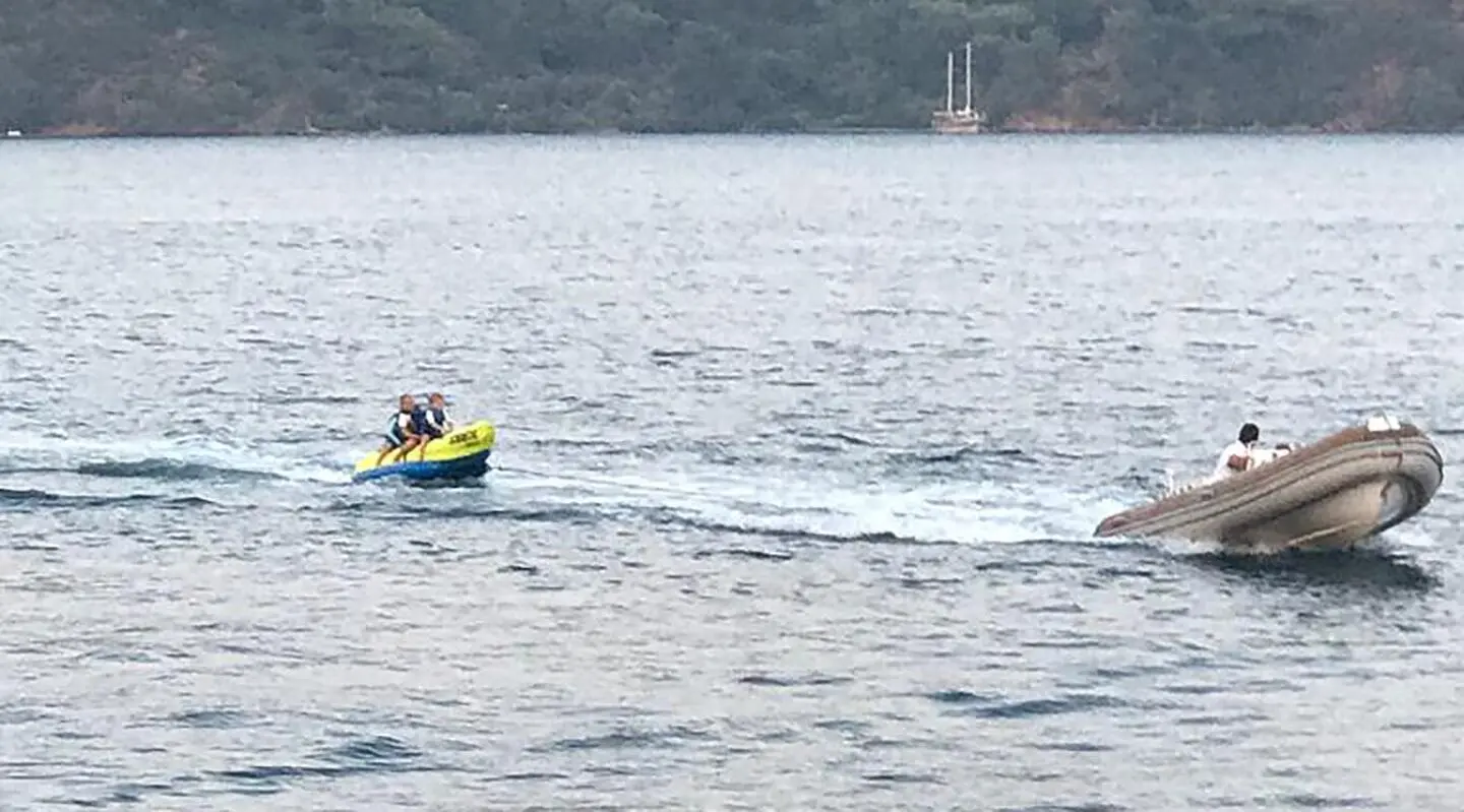 On the sea, the Prenses Bugce gulet with a small inflatable motorboat nearby in motion