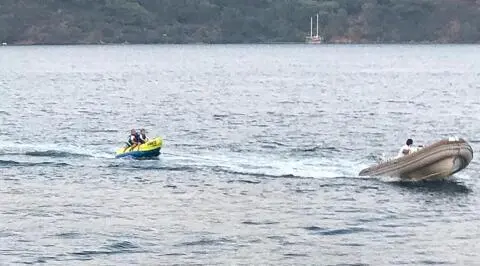 On the sea, the Prenses Bugce gulet with a small inflatable motorboat nearby in motion