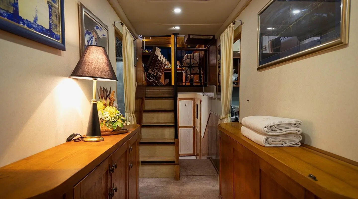 Aborda yacht interior with wooden stairs, cabin lighting, and compact galley