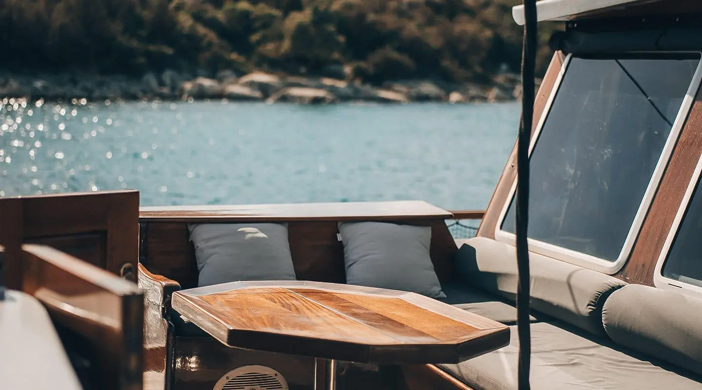 Sun deck on a Croatia-gulet yacht with wooden table and cushions