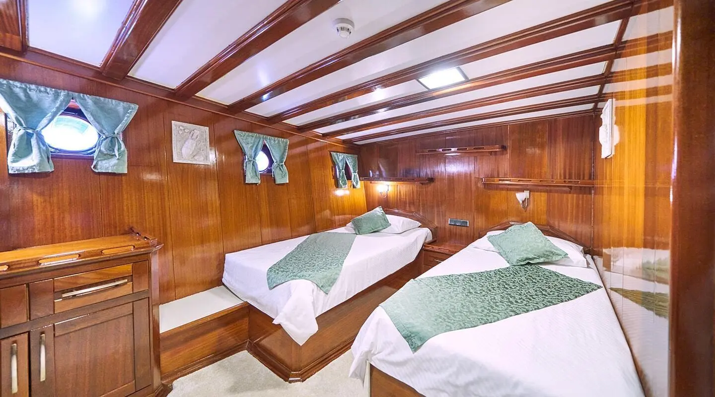 Stella Maris gulet interior with two beds and wooden panels