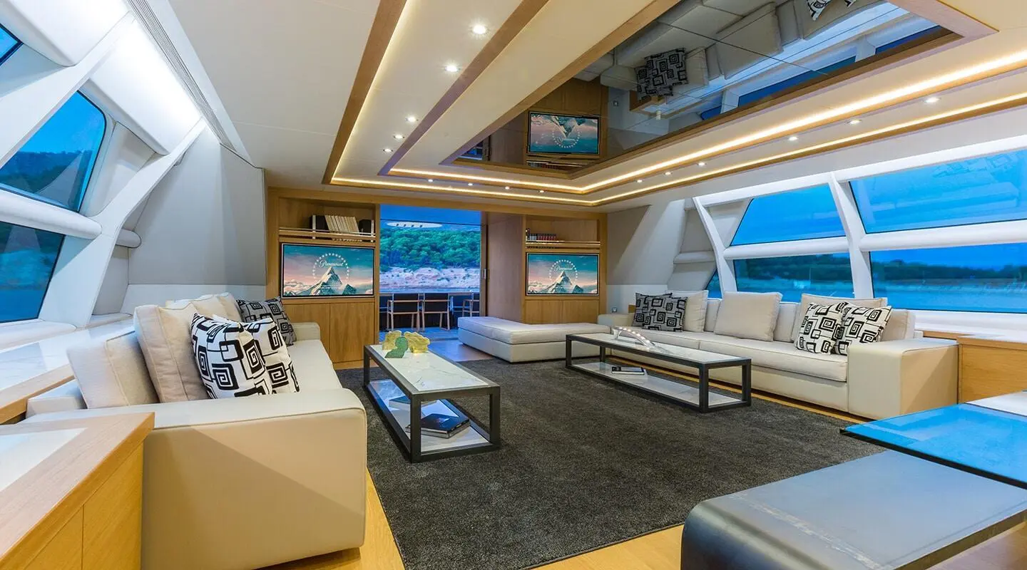 Aquarella yacht saloon interior with seating, coffee table, and windows