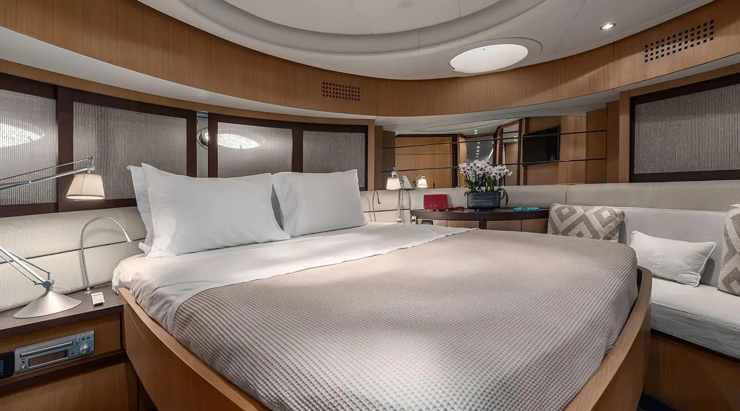 Interior view of One yacht master cabin with large bed and seating area