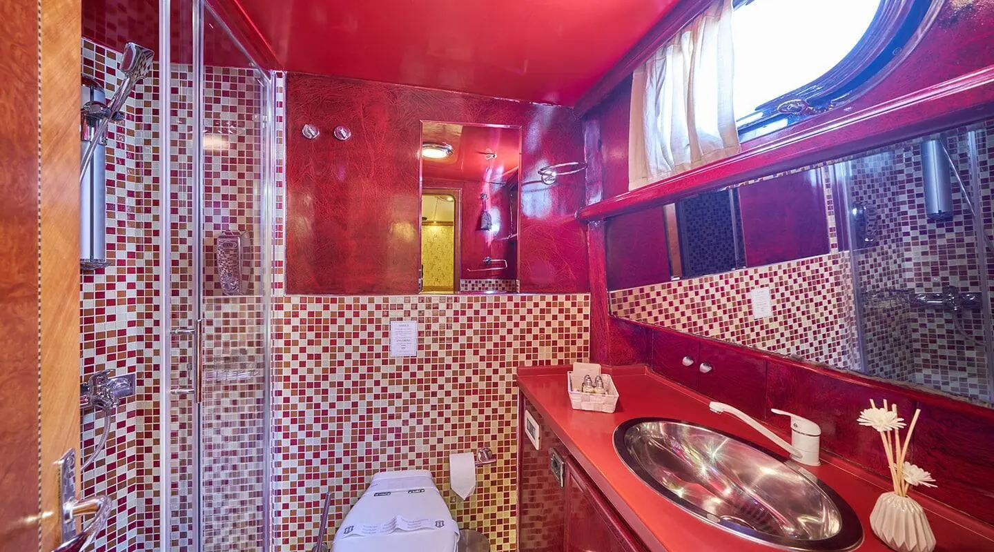 Luxurious red interior of yacht Lotus with ornate seating and pattern walls