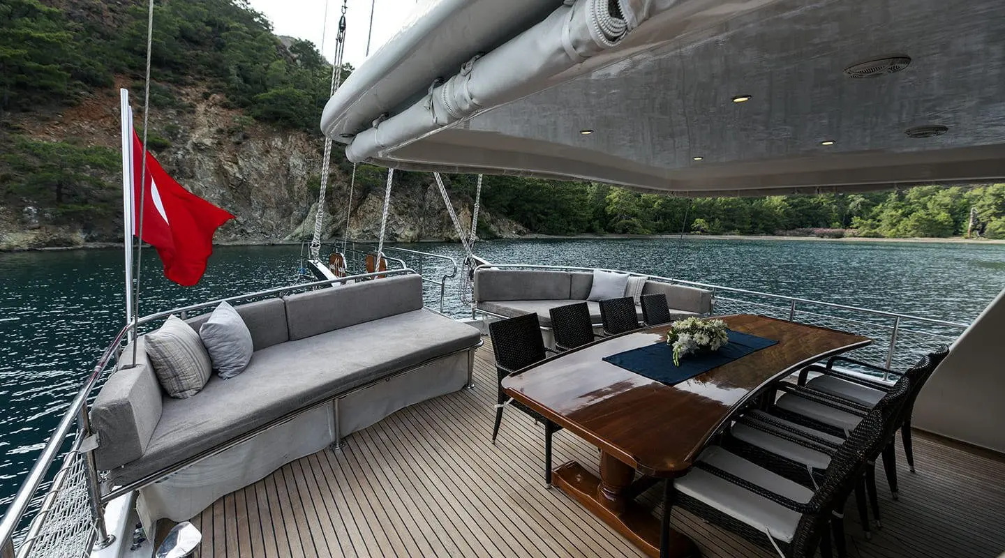 Kayhan 3 yacht deck seating area aboard luxury gulet at sunset with cushioned benches
