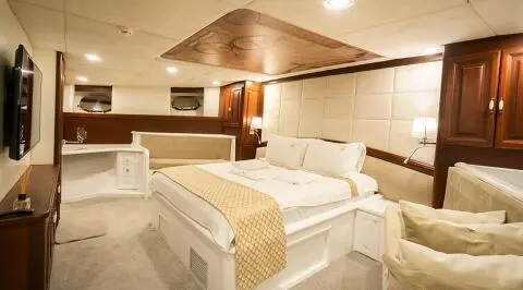 Gulet Virtuoso master cabin with two white beds and neutral decor