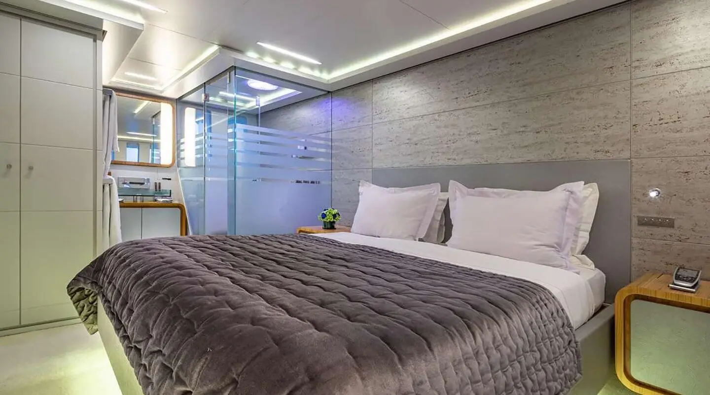 Sea Wolf luxury yacht bedroom with large bed and padded headboard