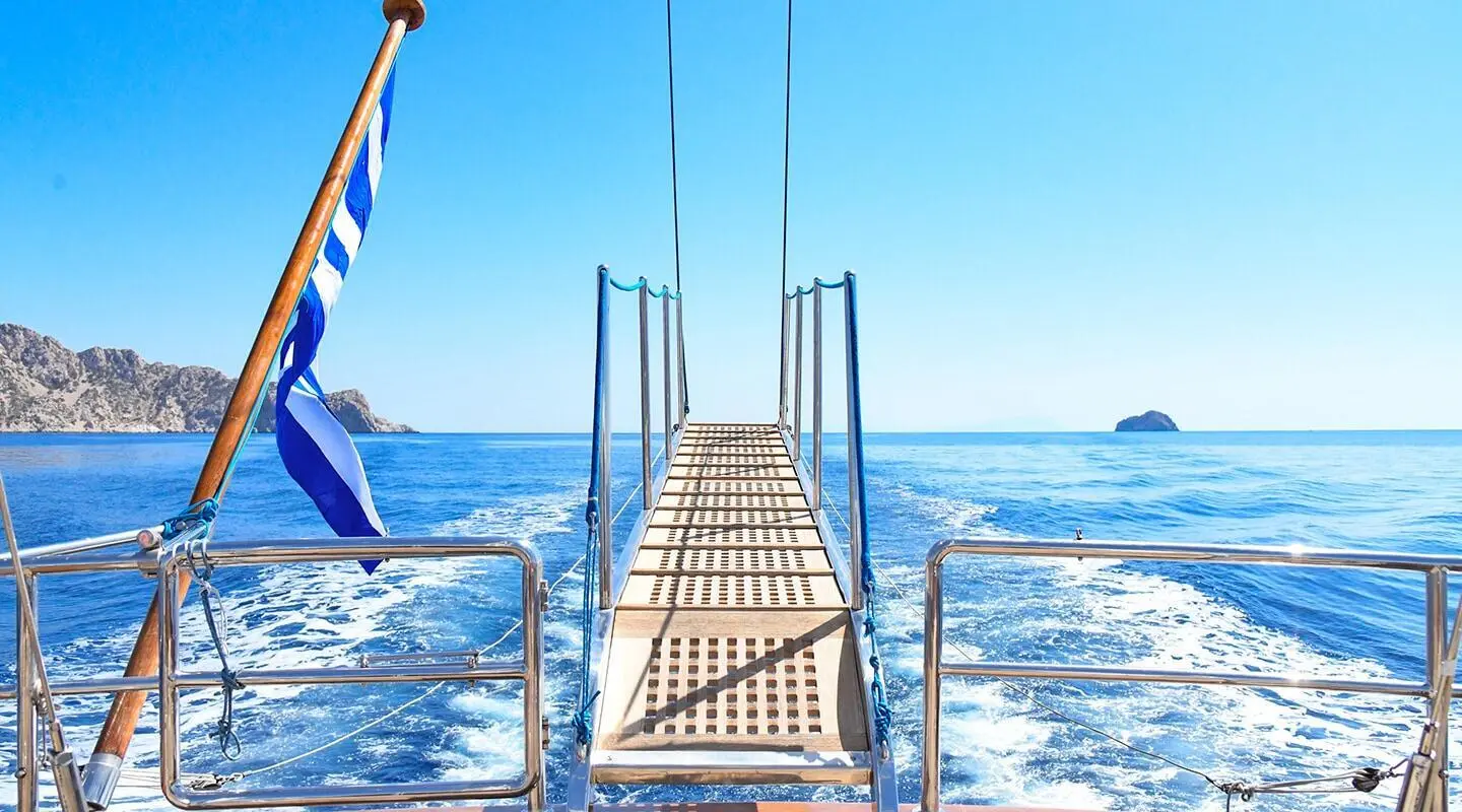 Tamarita yacht deck walkway extending over blue sea with clear sky
