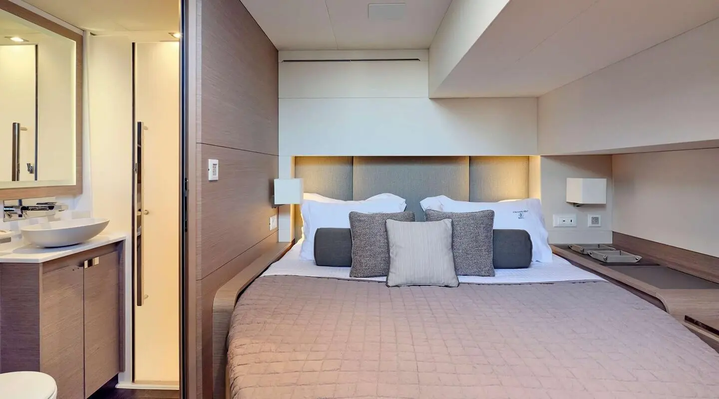 Luxurious yacht bedroom on Christal Mio with neutral tones and plush bed