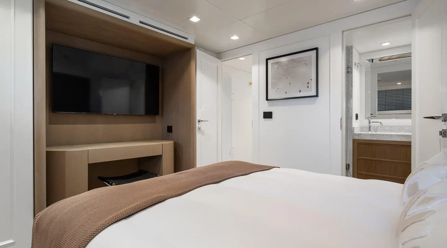 Illusion II yacht salon interior with bed, seating, and soft lighting