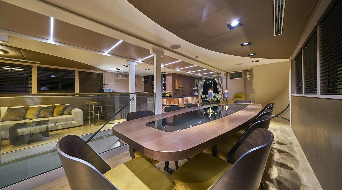 Interior of Rara Avis gulet with a large wooden table and chairs