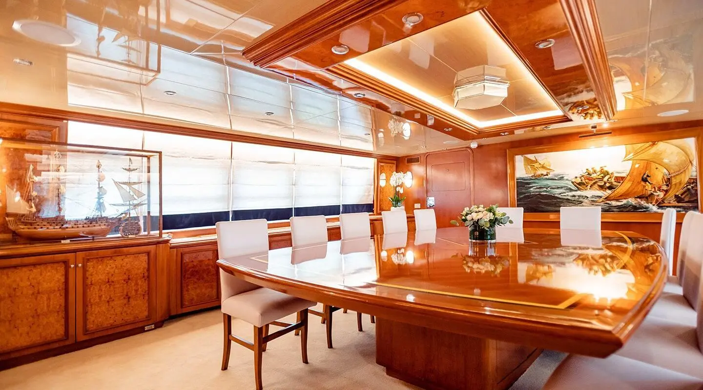 Luxurious meeting room with a glossy wooden table and white chairs