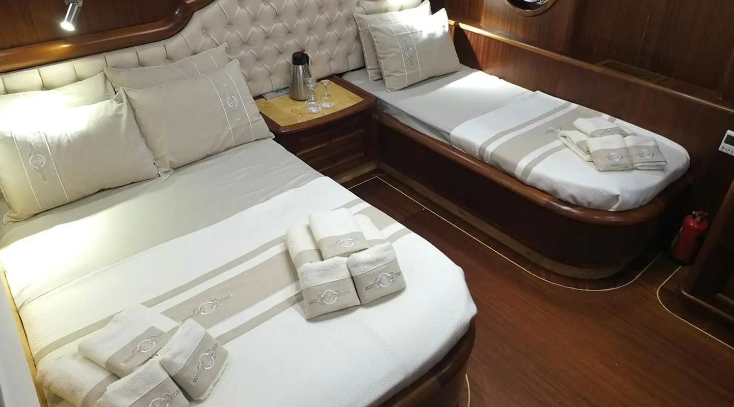 Luxurious deck of Kaptan Mehmet Bugra yacht with sun loungers and pillows