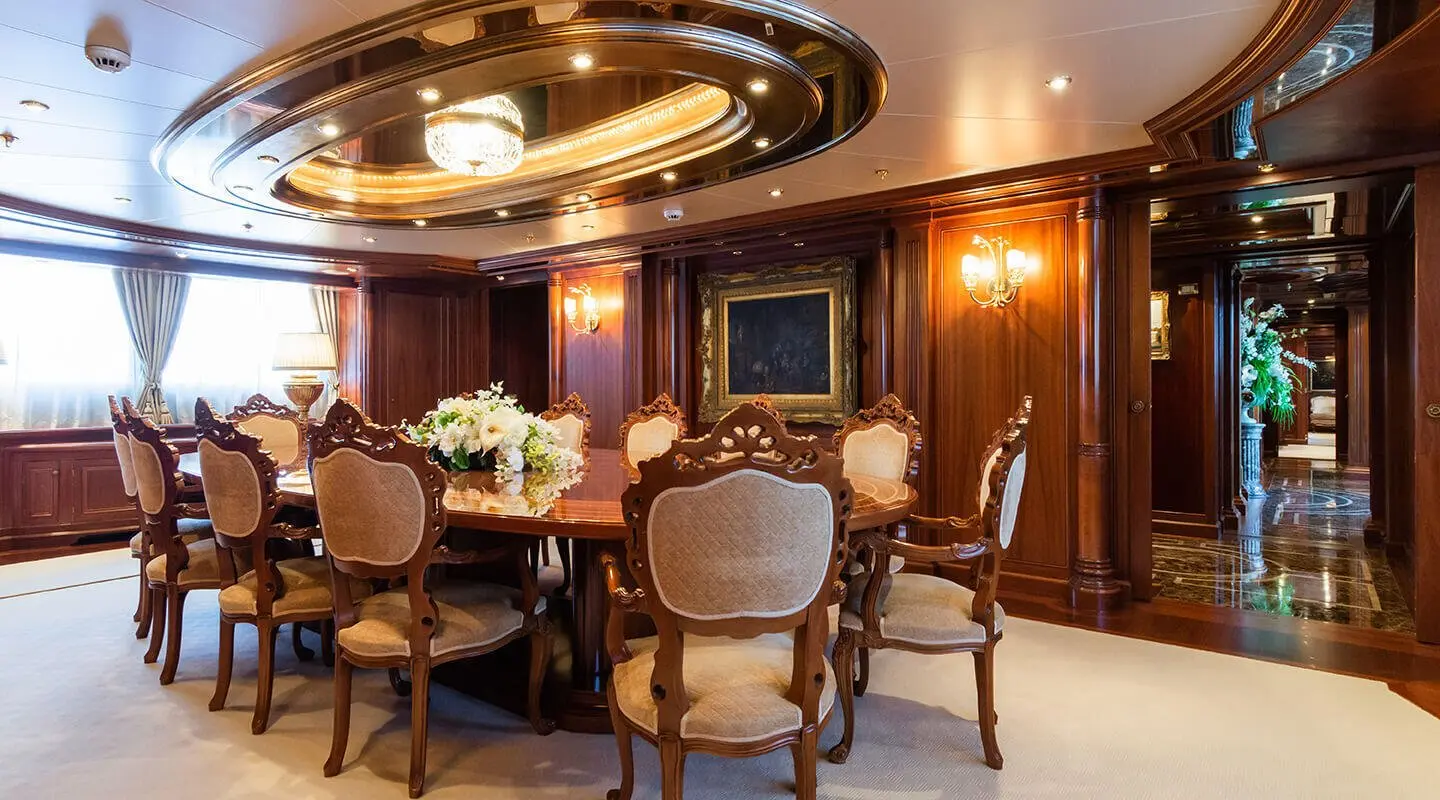 Luxurious wood-paneled dining room with ornate chairs around a table
